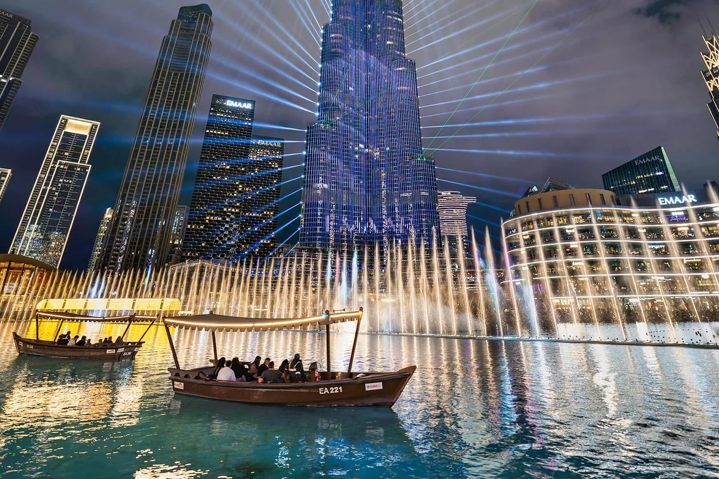 The illuminated Dubai Fountain beneath the Burj Khalifa at night