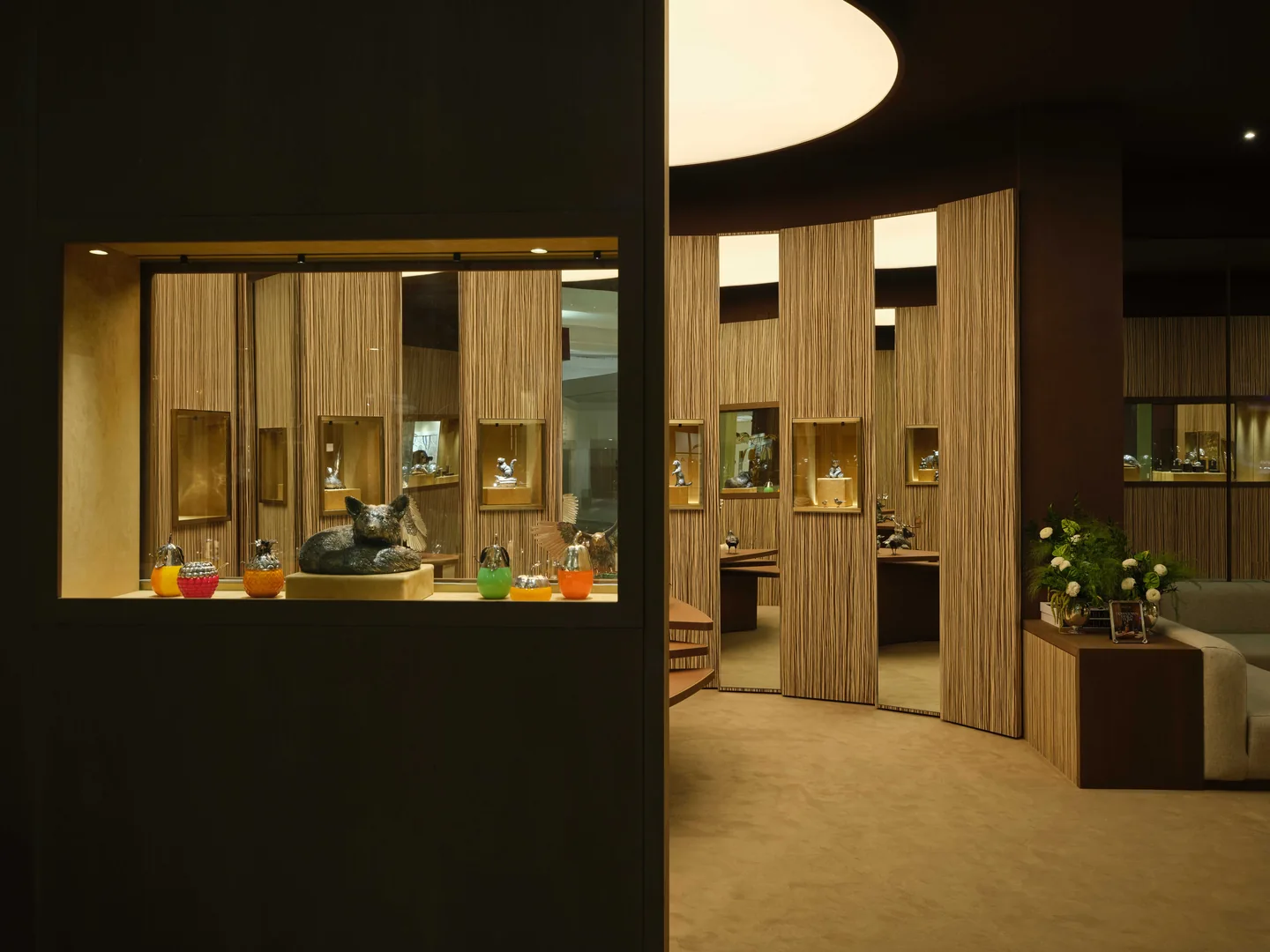 Furniture and warm wooden display surfaces in the Buccellati pavilion at Downtown Design 2025